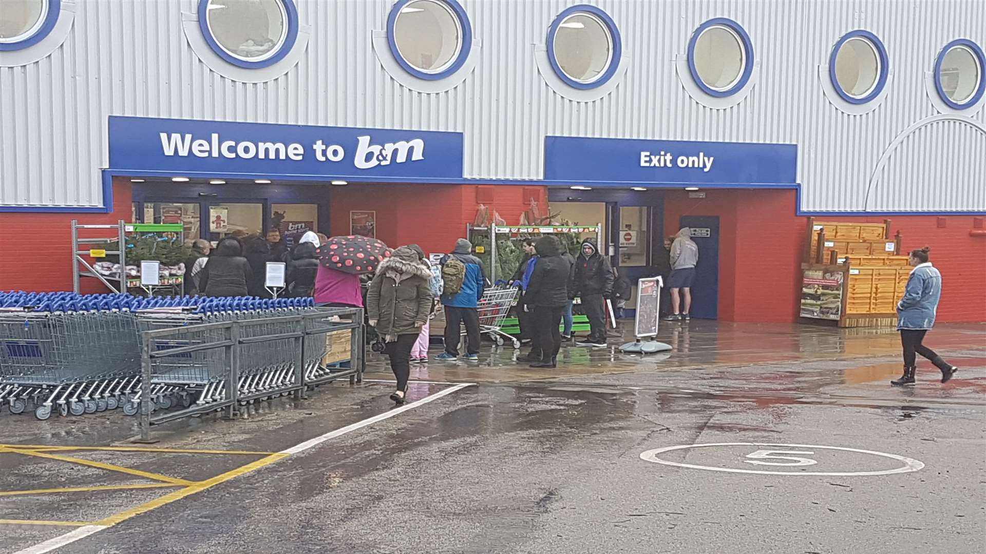 Shoppers waited in the rain for the shop to open today