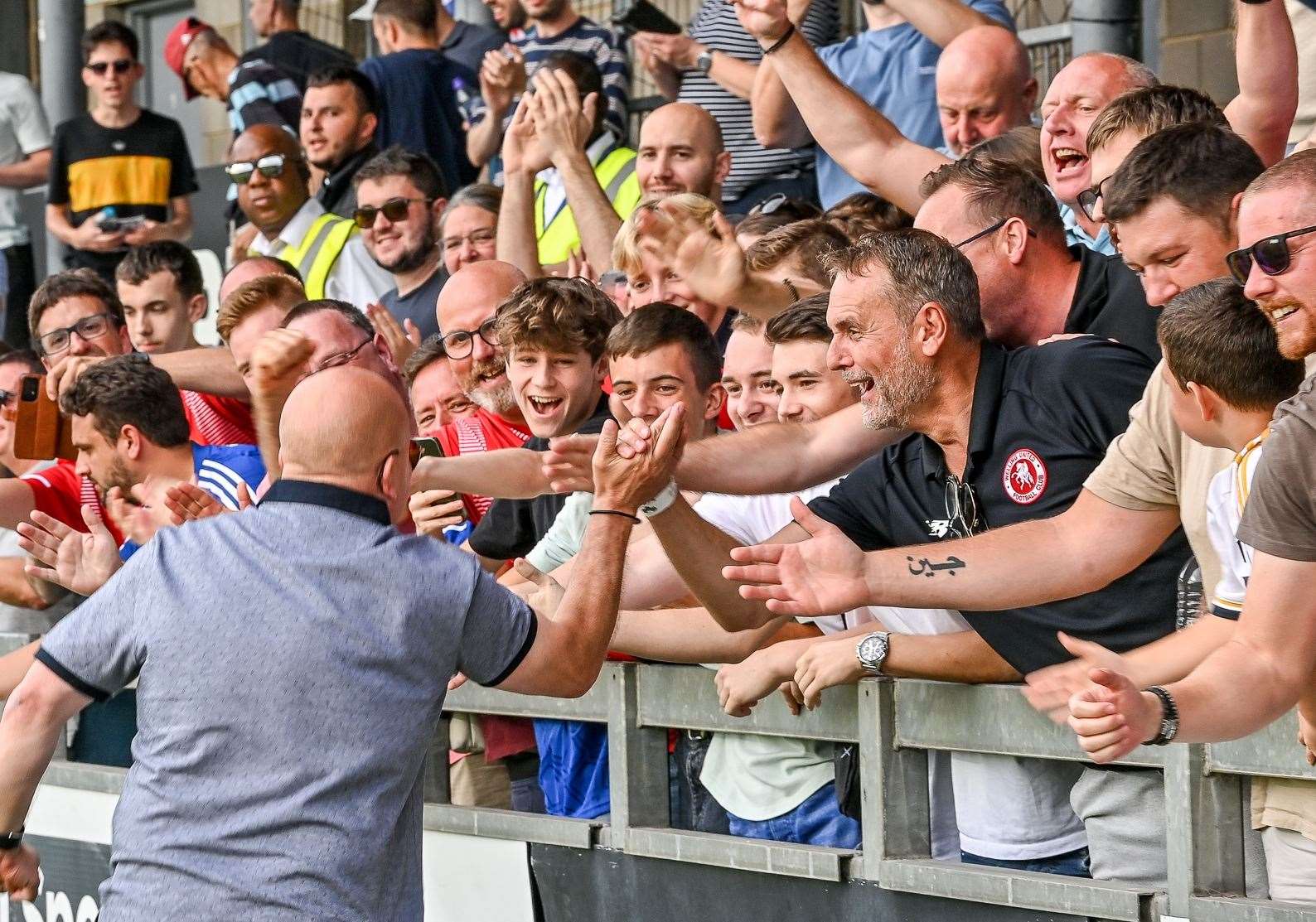 Welling manager Danny Bloor celebrates with the club’s fans after their 3-2 derby FA Cup win at Dartford on Saturday. Picture: Dave Budden