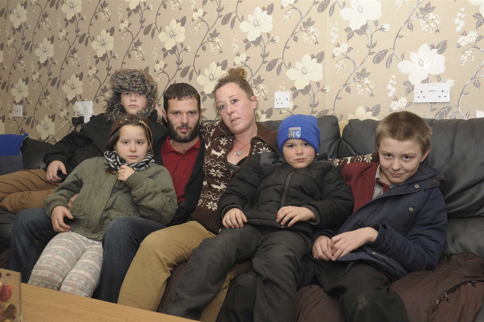 The family wearing coats to keep warm. From left to right: Kelsey-Rose, 9, Nicola and Ian, Callum, 13, Shayne, 7, and Aiden, 15. Picture: Steve Crispe