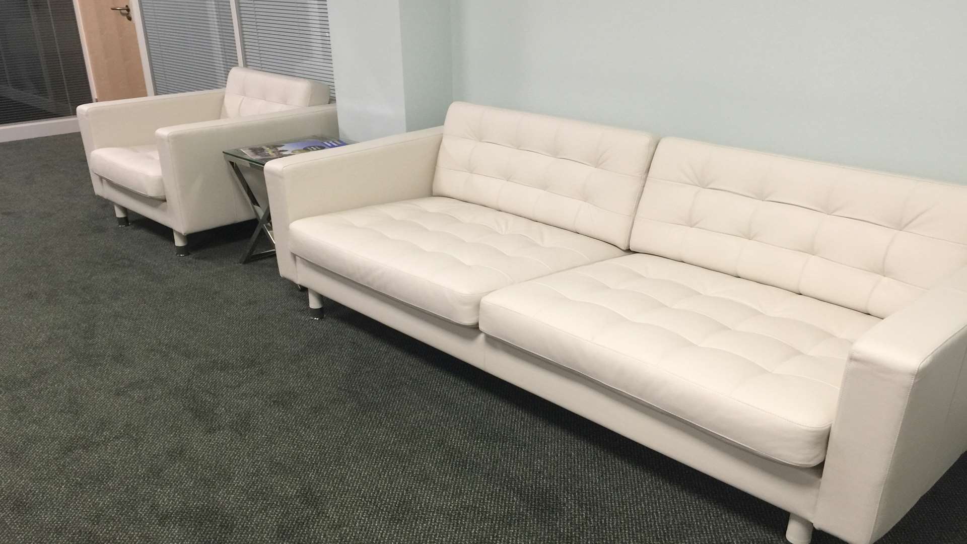 White leather sofas are seen in the reception area.
