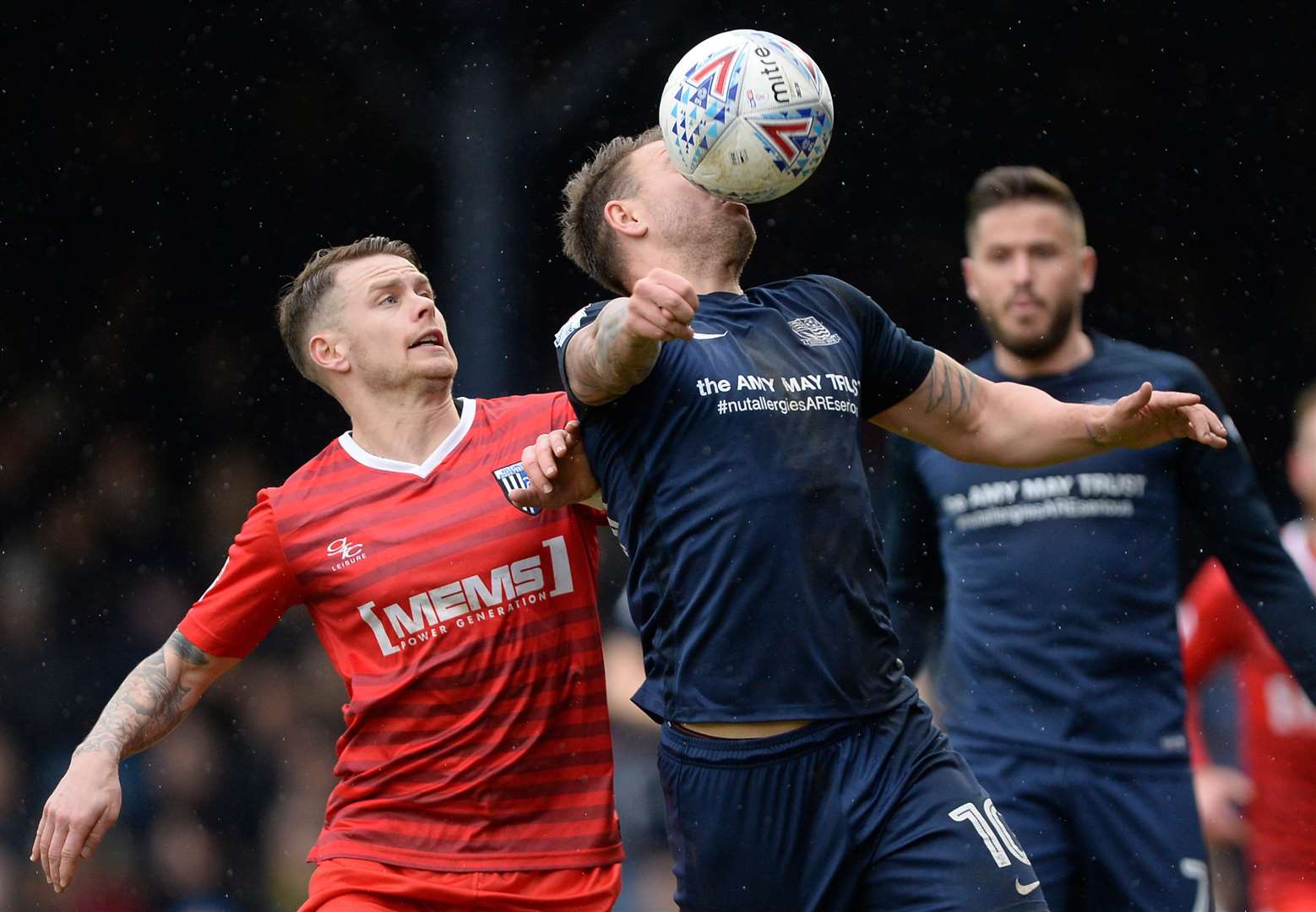 Simon Cox keeps his eye on the ball, under pressure from Gillingham's Mark Byrne. Picture: Ady Kerry