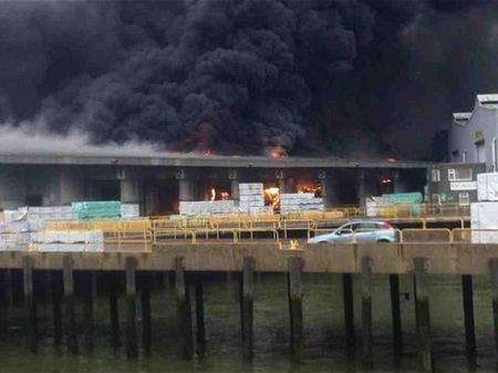 Flames are seen at the site of the Sheerness warehouse blaze.