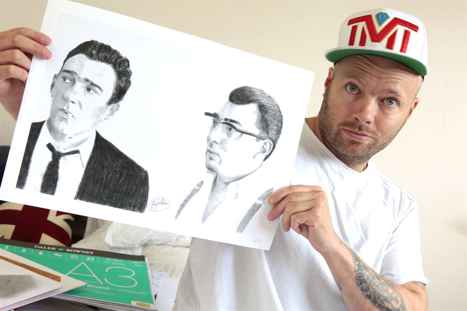 Jay displays his sketch of the Kray twins