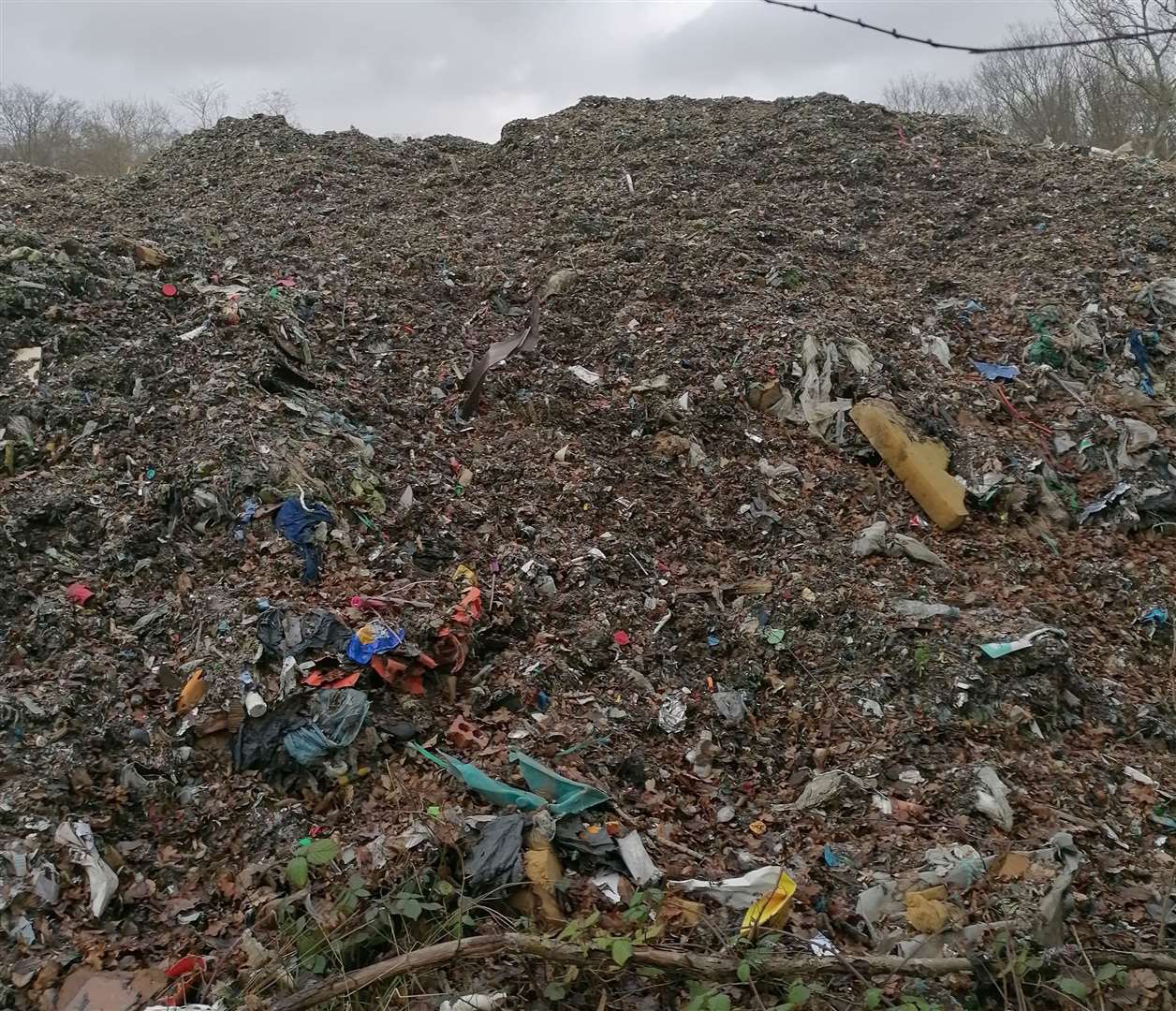 Rubbish is piled 12ft high across acres of Hoad’s Wood, near Ashford