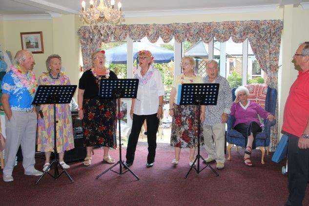 Singers, Spare Parts, on song during Pine Lodge Care Home's Hawaii-themed fundraising afternoon.