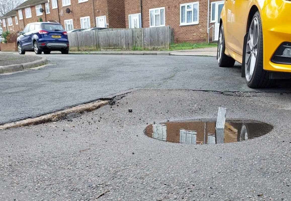 A brick was placed in the puddle before it became a pothole