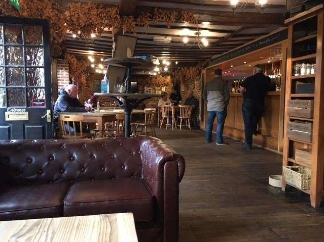 The large front bar is heavily beamed with stripped wooden floors but despite the small windows highly effective lighting makes it bright and airy