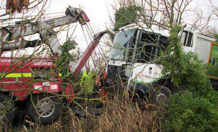 Dustcart overturns in ditch