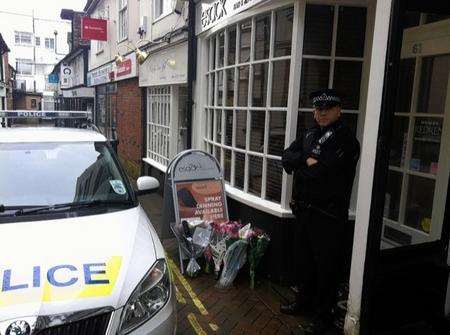 Floral tributes outside Esack hair and beauty where owner Natalie Esack was stabbed on Monday morning.