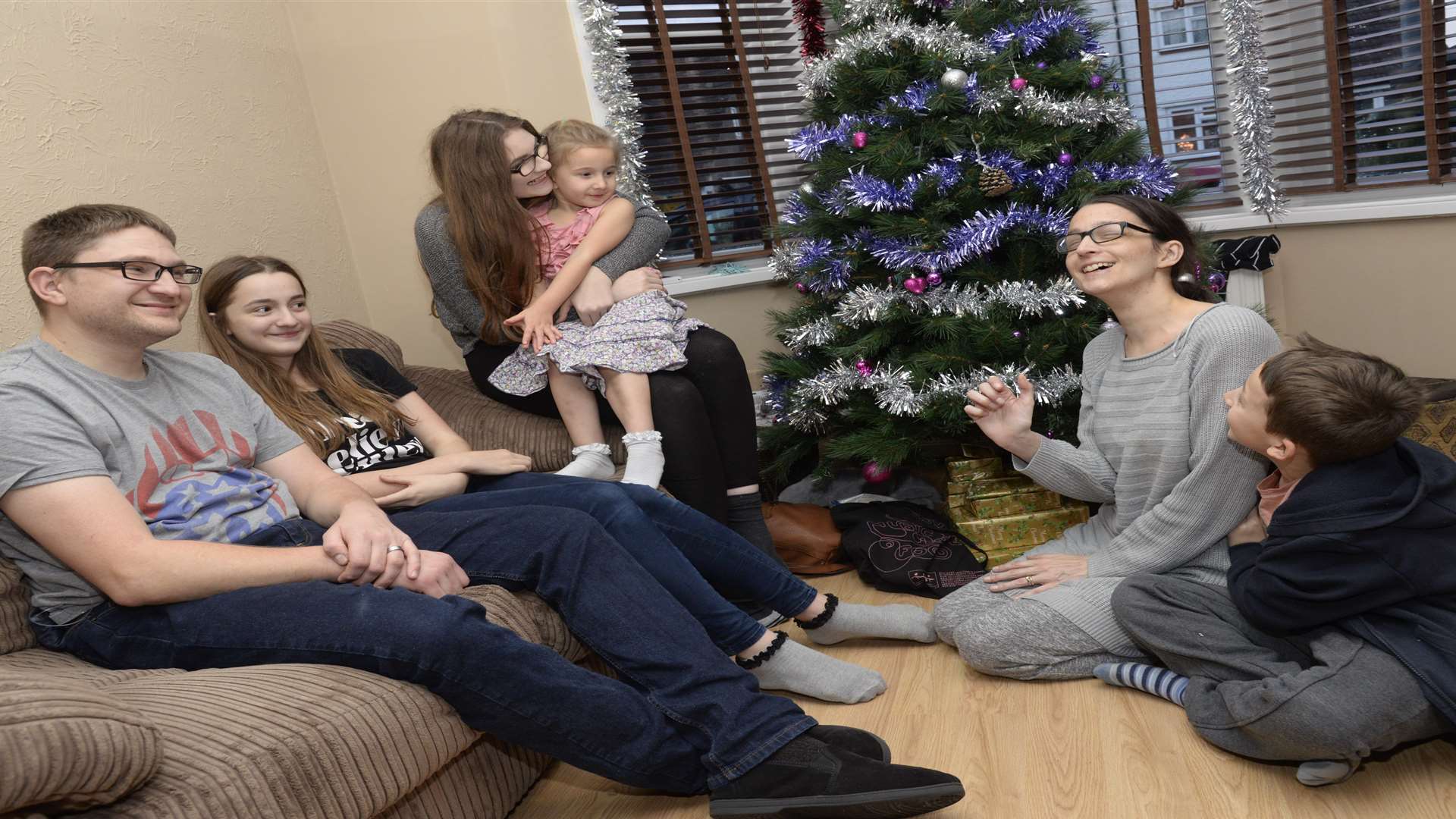 Clare Coleman and her family around the Christmas tree at their home