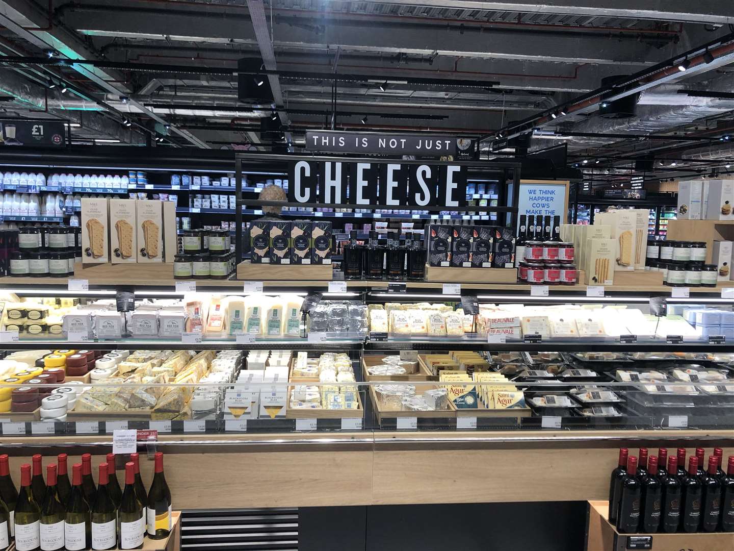 The cheese counter along with crackers and wine