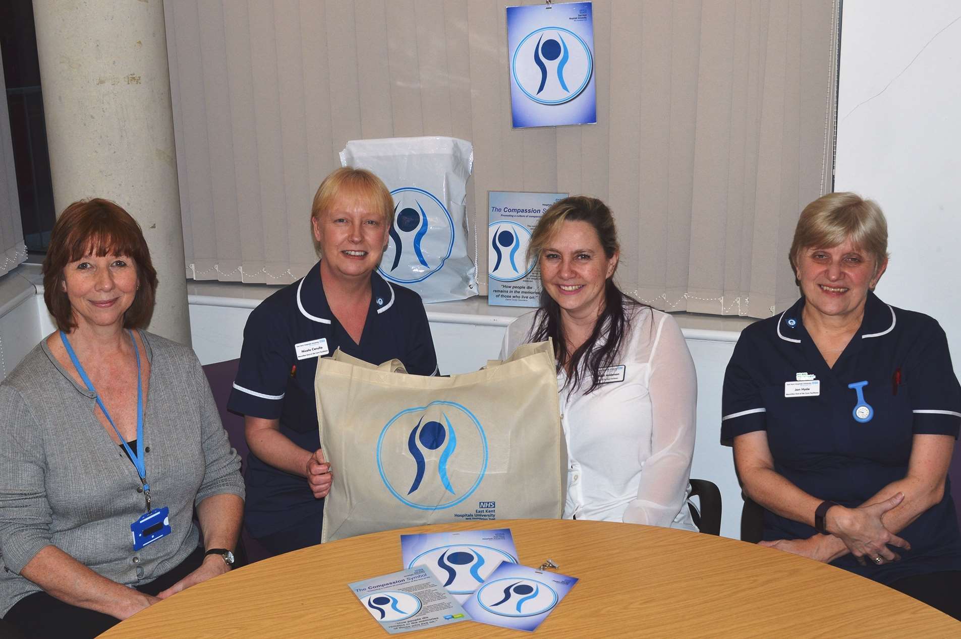 Hospice staff and nurses with the 'compassion' signs