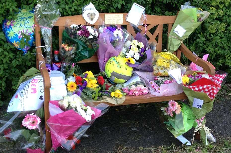 Floral tributes to Ben Simmonds on Ben's Bench at Sheppey Sports and Social Club