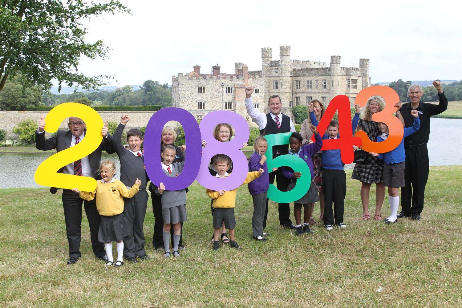 Celebrating getting more than 200,000 car journeys off the road are sponsors from left, David Cavender (Specsavers), Margaret Brook (IMP), Hannah Lawrence (Leeds Castle), Matt Trusty (Specsavers), Elizabeth Carr (Mini Babybel), Libby Lawson (KM) and Nicholas Brook (IMP) with KM Walk to School participants at Leeds Castle
