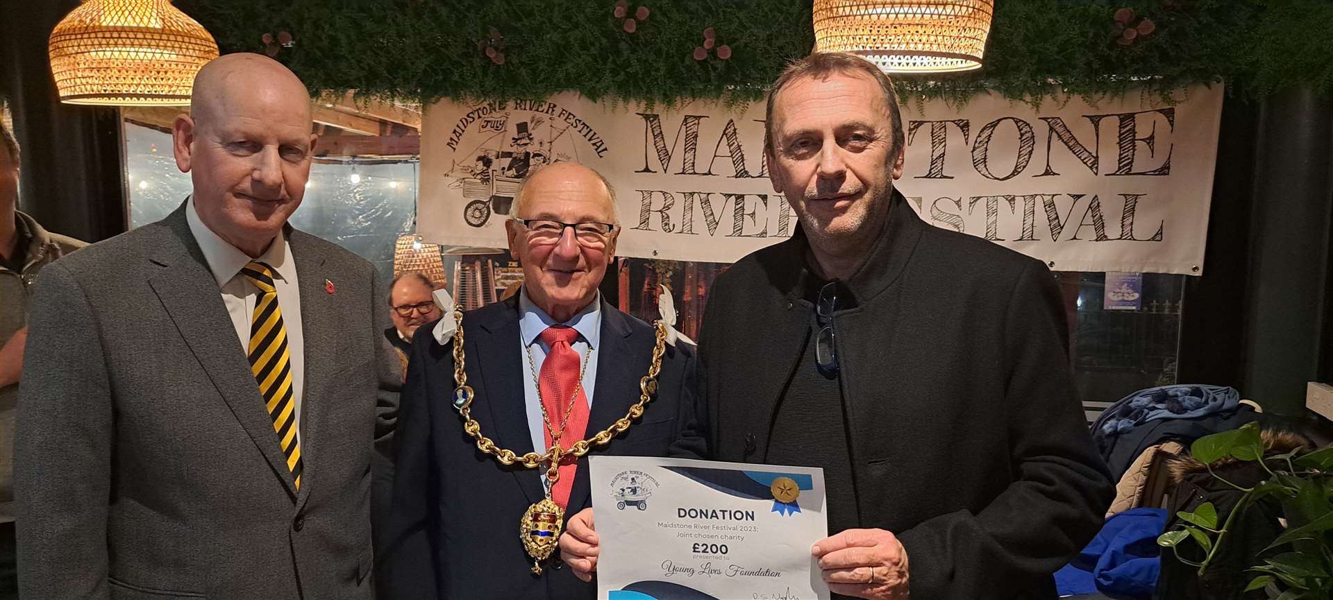 Neil Vickery receives a £200 donation from the River Festival on behalf of the Young Lives Foundation, with Dave Naghi and the mayor Gordon Newton