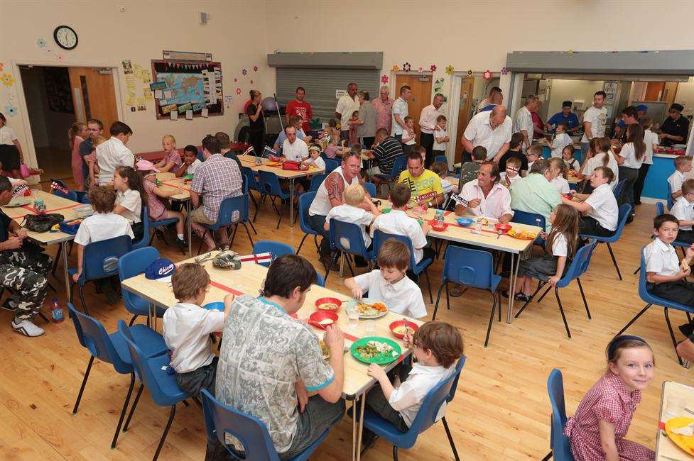 Children and fathers enjoying their lunch at school