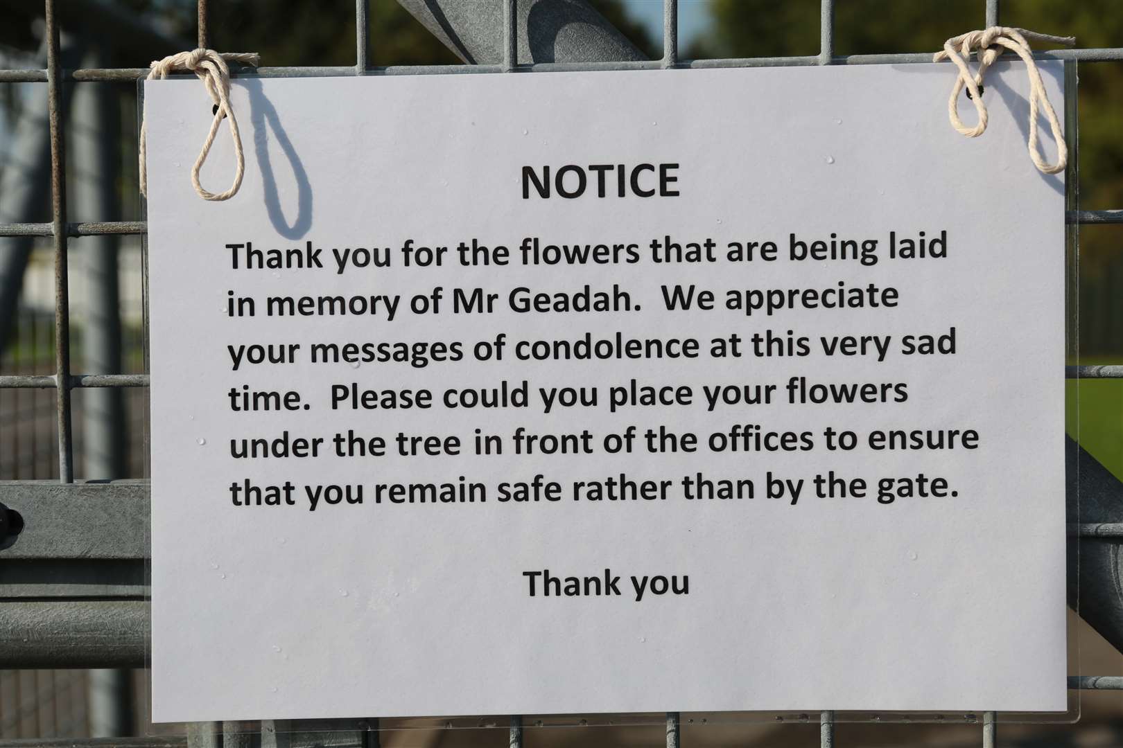 The notice outside the school near the floral tributes
