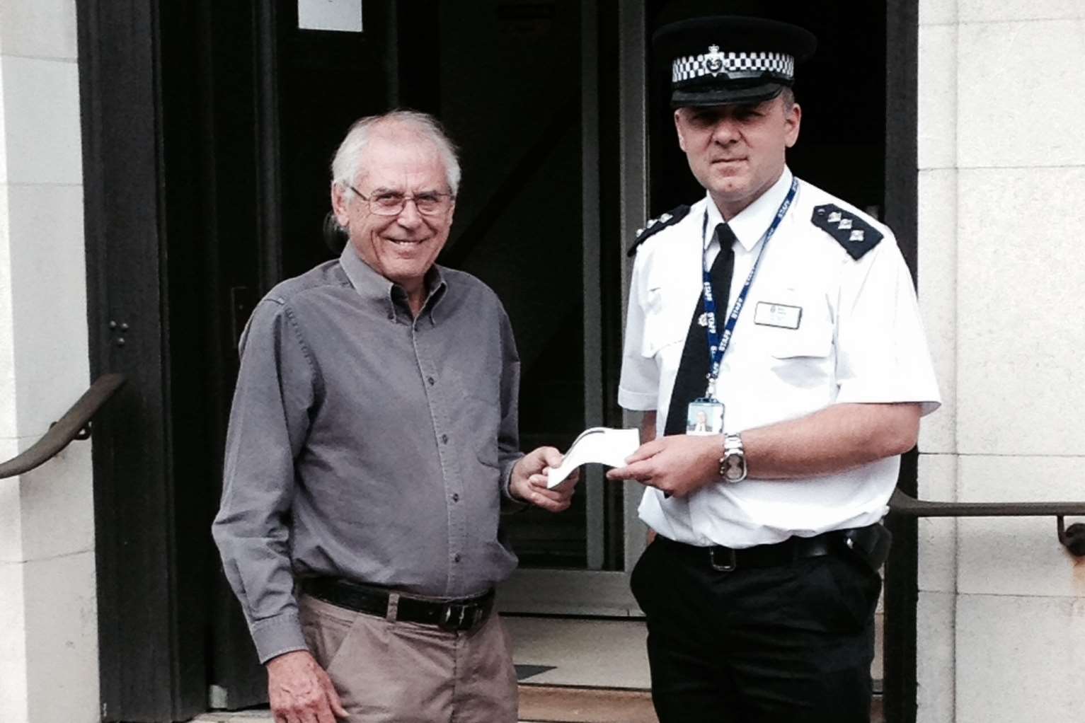Chief Inspector Dave Pate, presenting a cheque to Mental Health Resource chairman Len Horwood