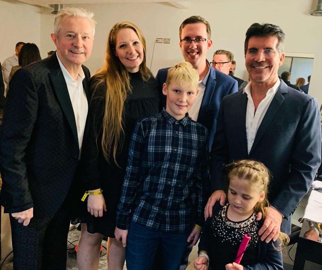 Hallie with her family, and X-Factor judges Louis Walsh and Simon Cowell. Pic: Demelza Children's Hospice