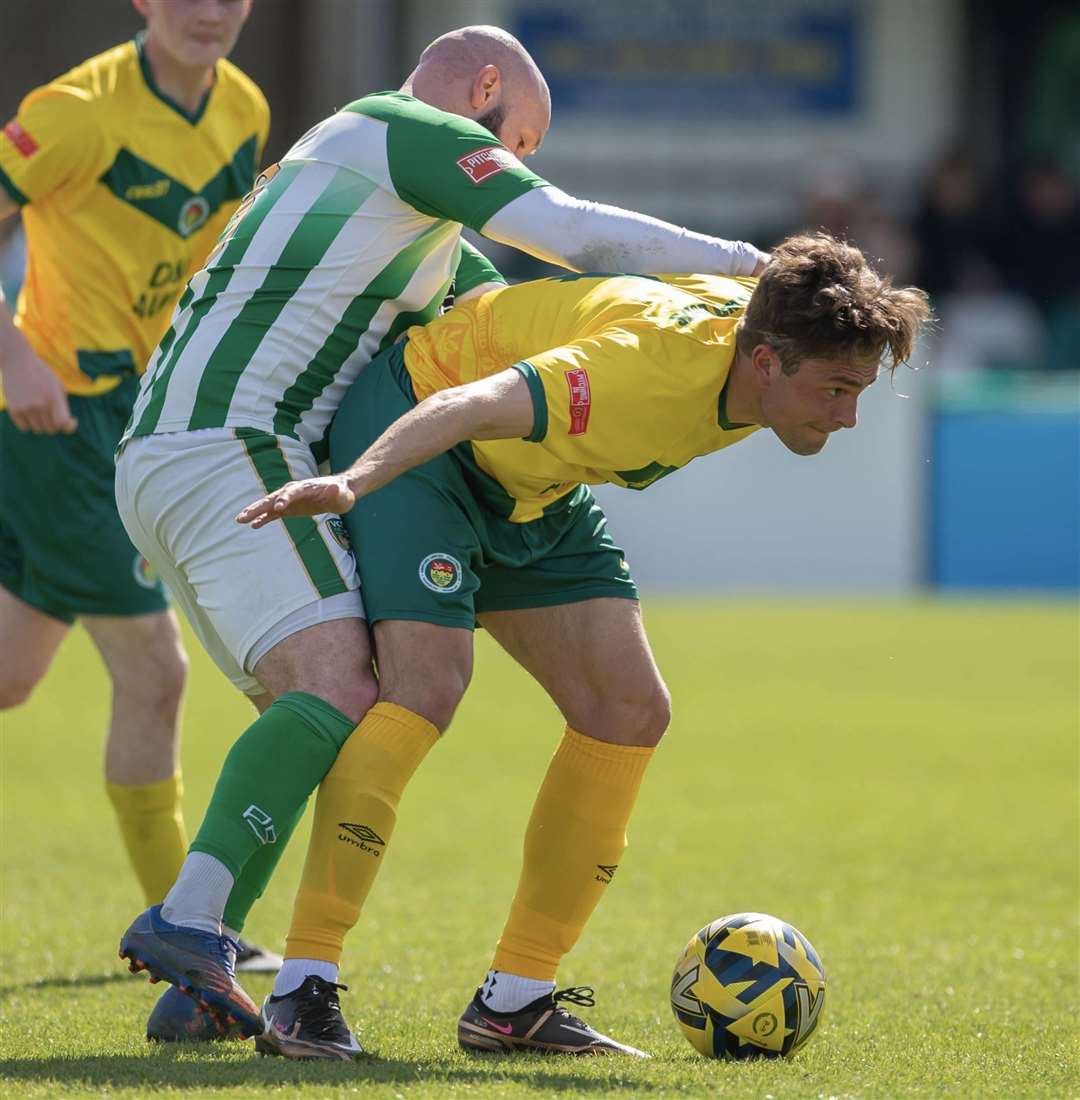Ashford midfielder Rhyle Ovenden shields the ball. Picture: Ian Scammell