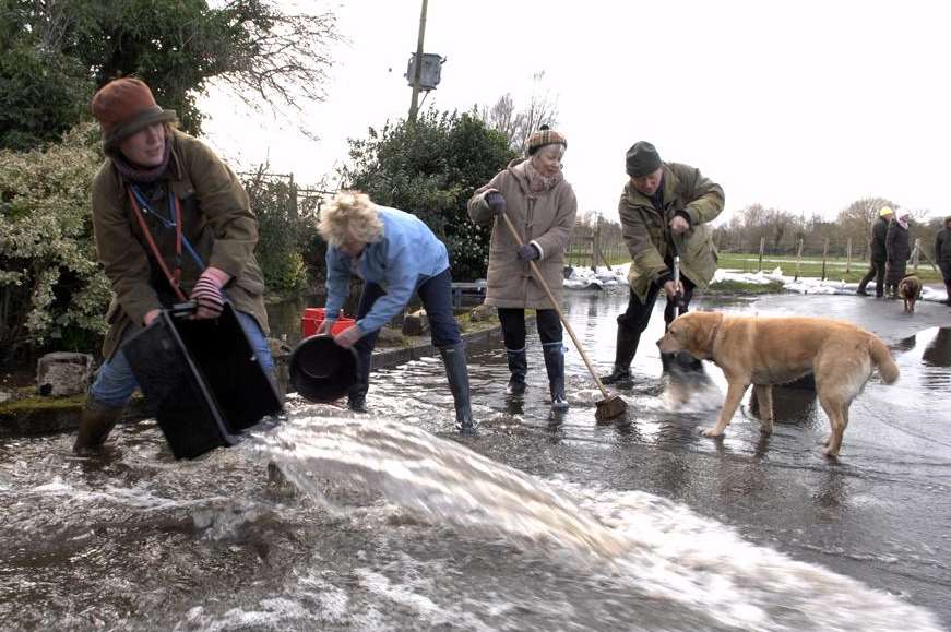 Villagers did their best to move floodwater away from homes in Seaton. Picture: Chris Davey