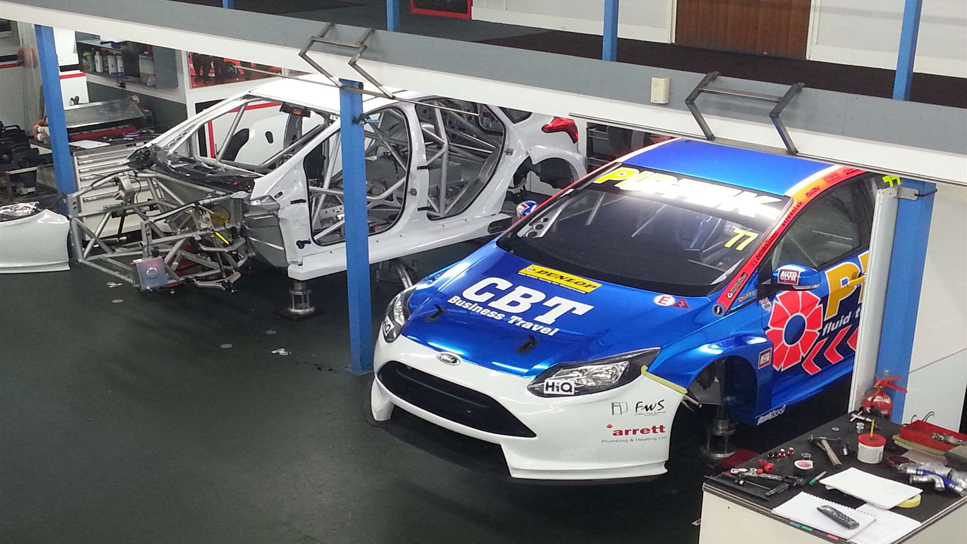 Andrew Jordan's Ford Focus alongside Mat Jackson's BTCC racer in the Motorbase workshop