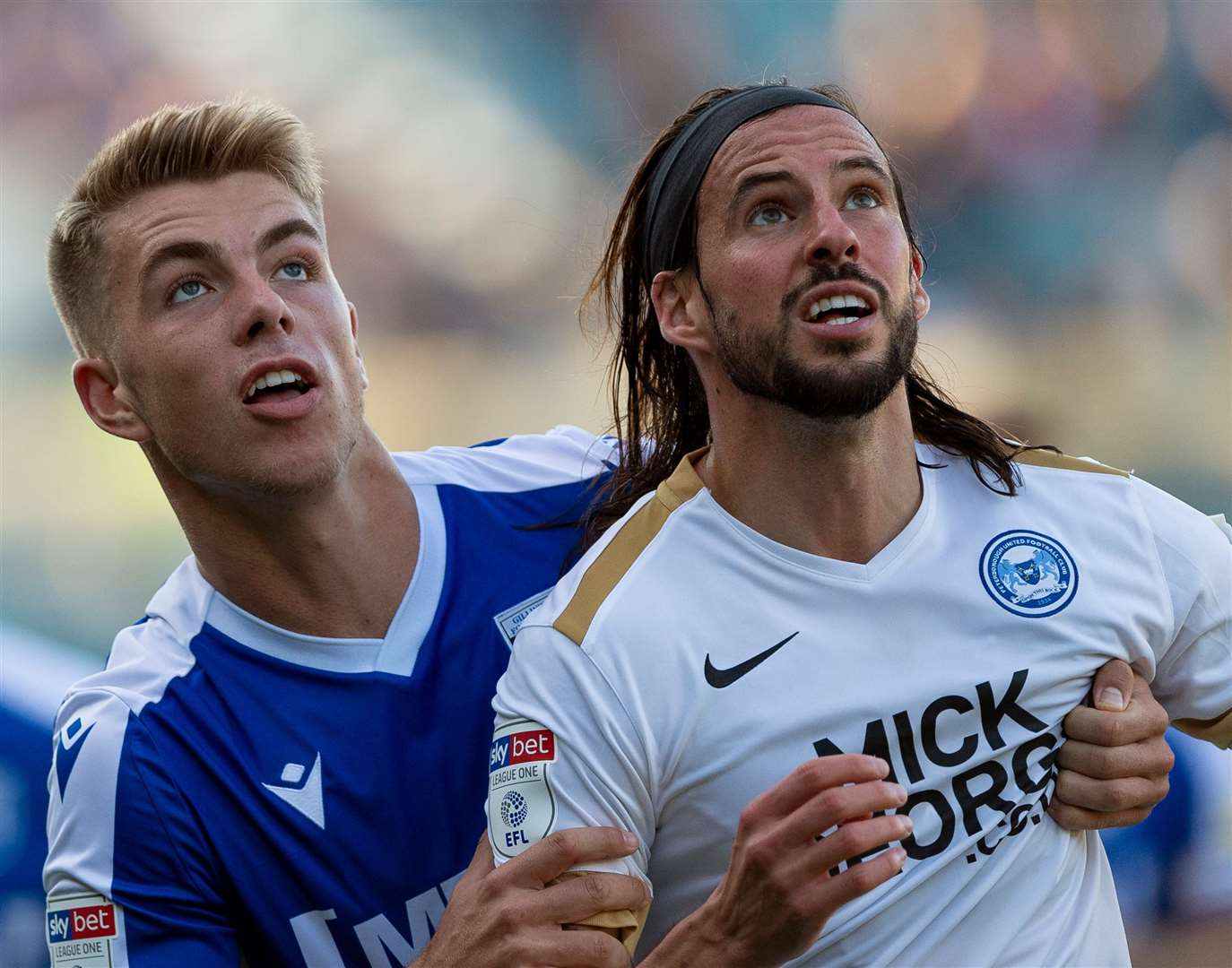 Jack Tucker keeps a tight grip on Peterborough's George Boyd Picture: Ady Kerry