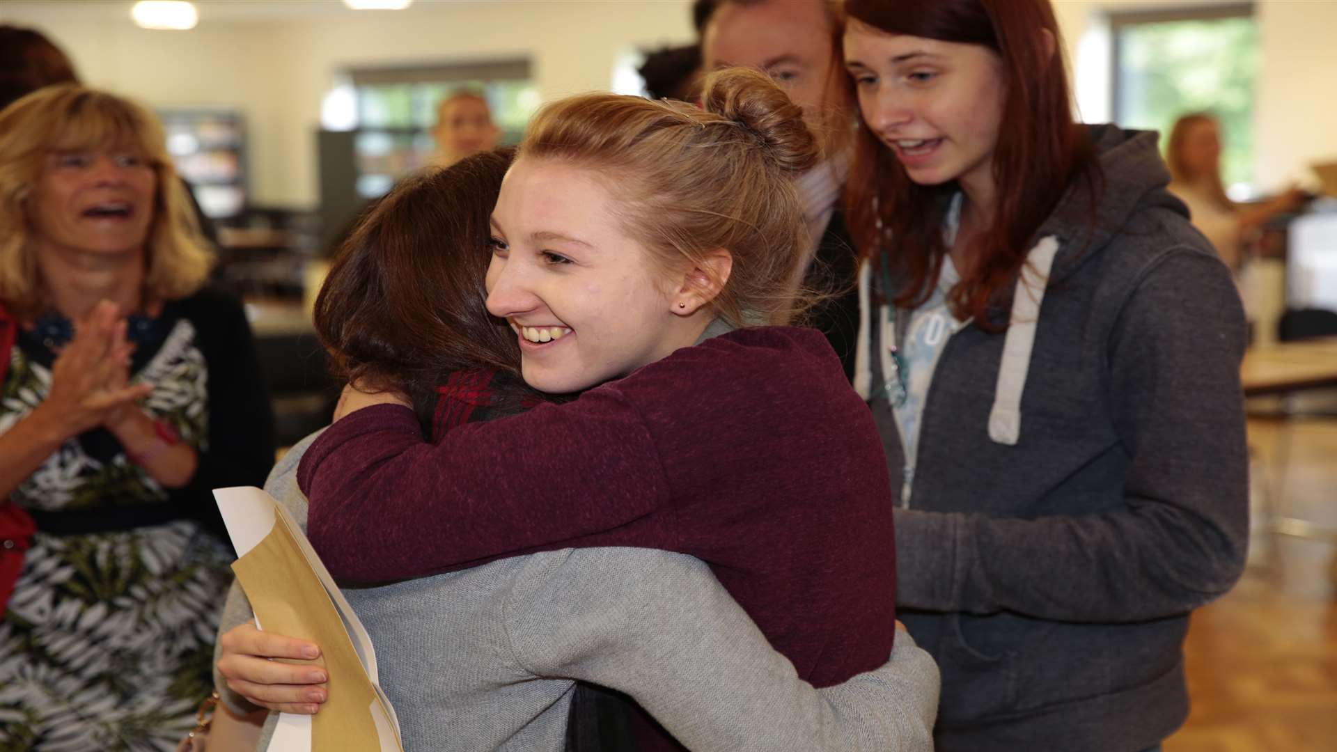 Jodie Russell hugs a friend after picking up her results at Valley Park School in Maidstone