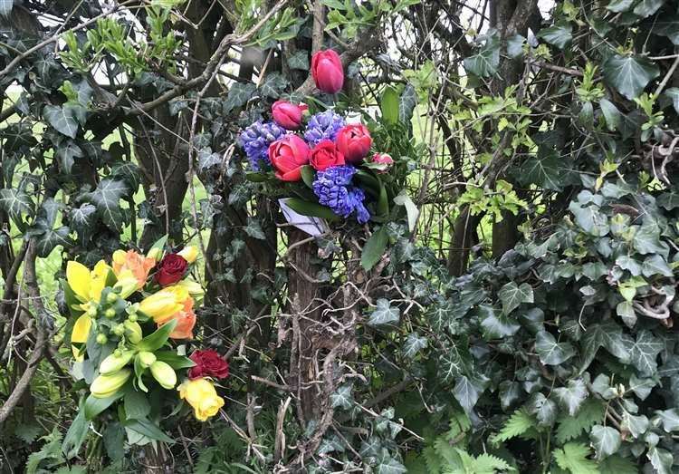 Floral tributes left at the scene of a fatal crash on the road in 2019