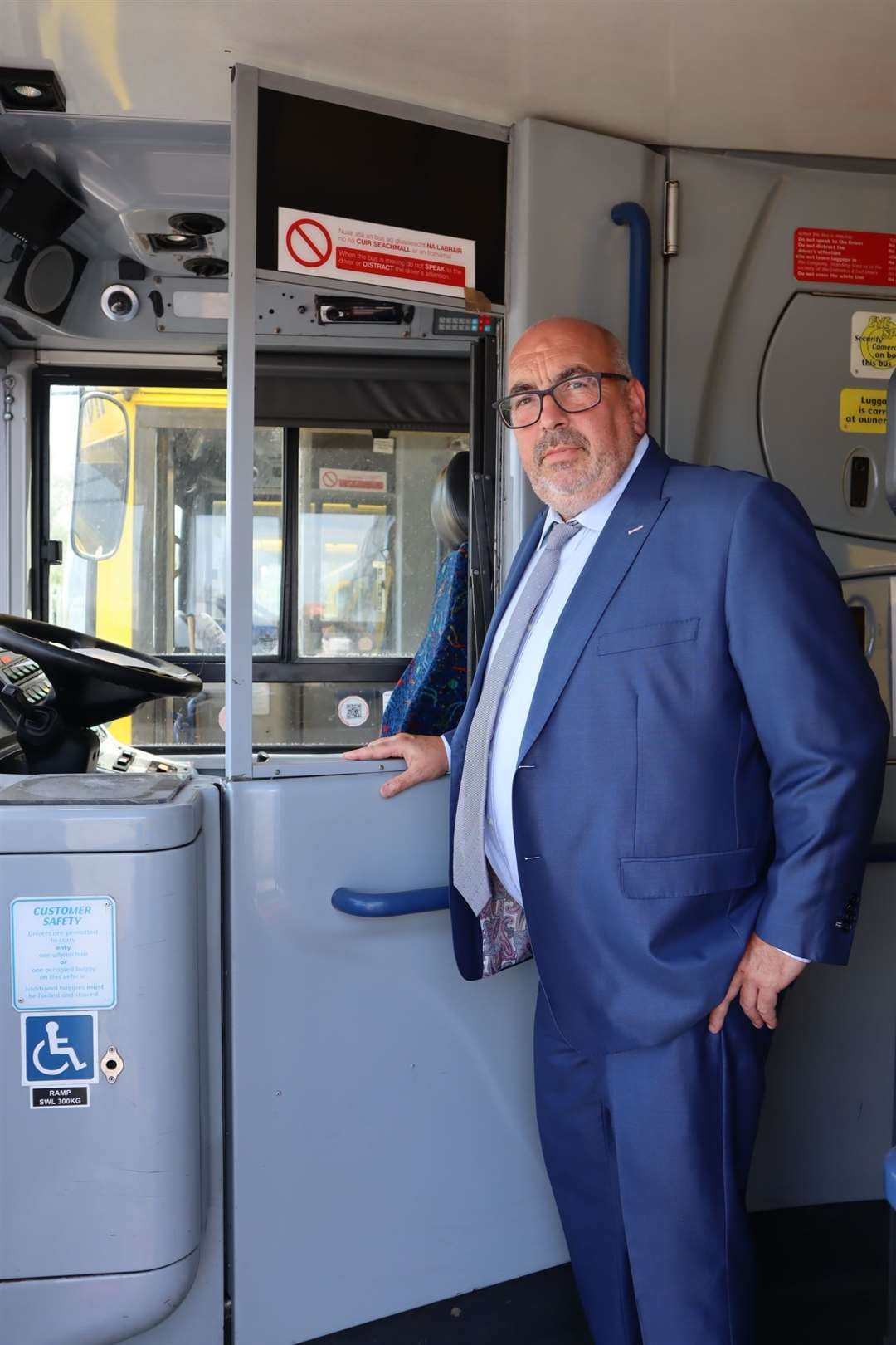 Tim Lambkin next to a driver's door shield being installed on all TravelMasters buses at the Sheerness depot on Sheppey