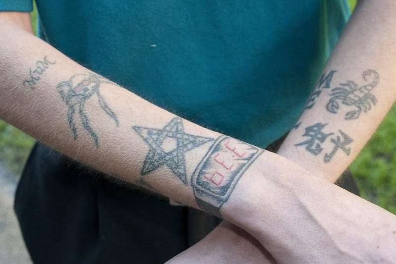 His arms show the variety of Neil Collins's tattoos
