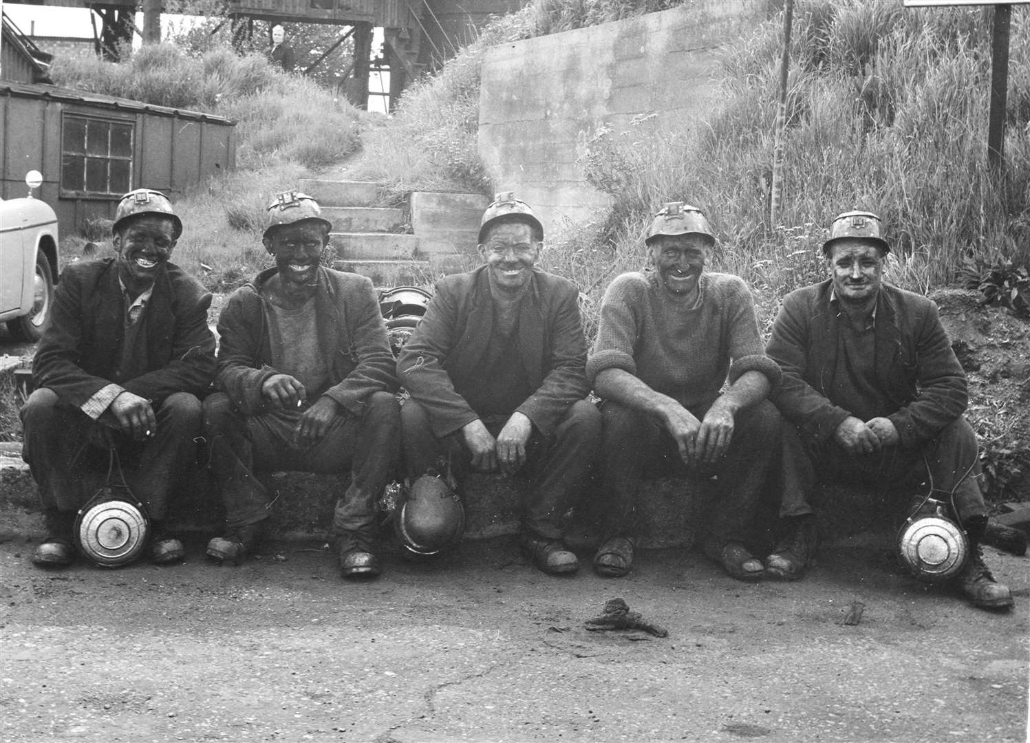 Fresh out of the pit, these bygone miners line up for a photo