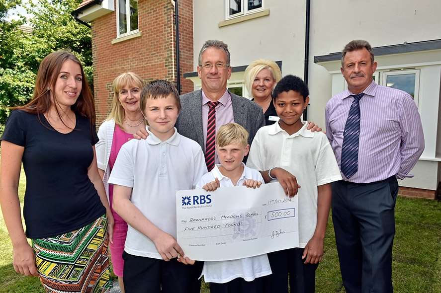 Children from Barnardo's Meadow School received a check for £500 from the home