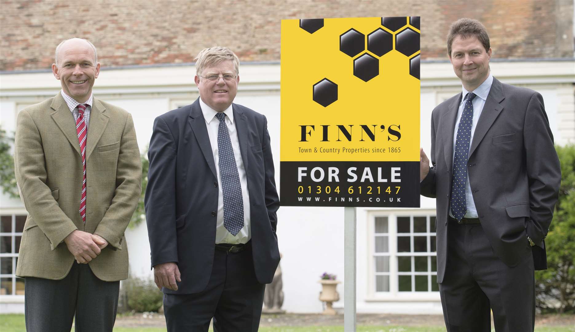 From left, Finn's partners Jim Pace, Julian Sampson and Nick Rooke with one of the firm's new property boards