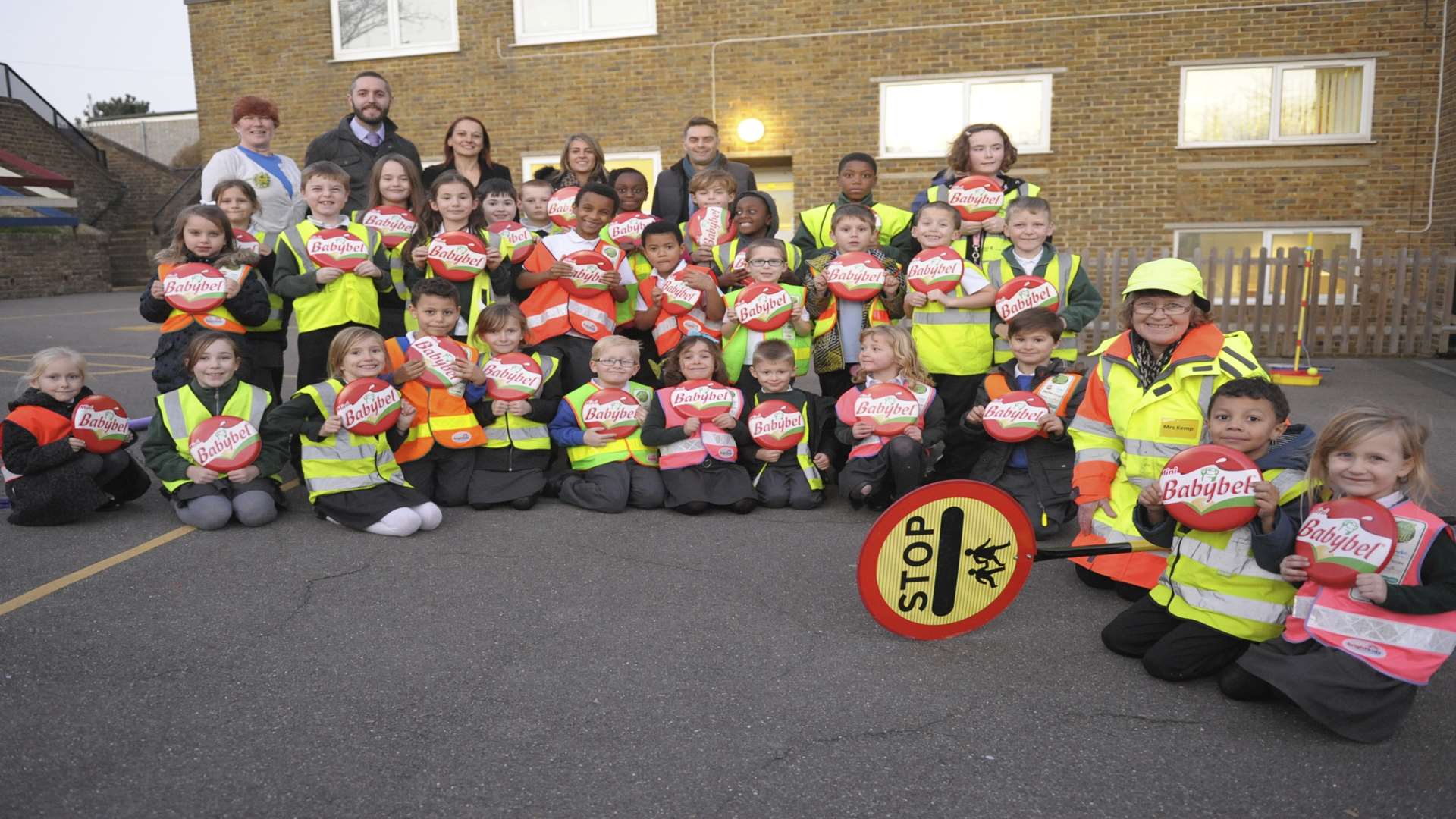 Back row from left: Wendy Gale, James Sutton (Medway Council), Amy Woods (Three R's), Claire Harris (Medway Council), Andrew Moon (Babybel) plus lollipop lady Jane Kemp with pupils at Gordon Junior School, Gordon Road, Strood.