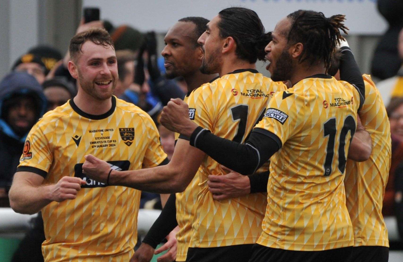 Maidstone’s George Fowler, left, joins the celebrations after Sam Corne's penalty against Stevenage in round three. Picture: Steve Terrell