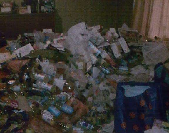 Empty bottles and paper cover the carpet