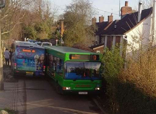 Traffic queued after these two buses got stuck in Long Mill Lane this morning.