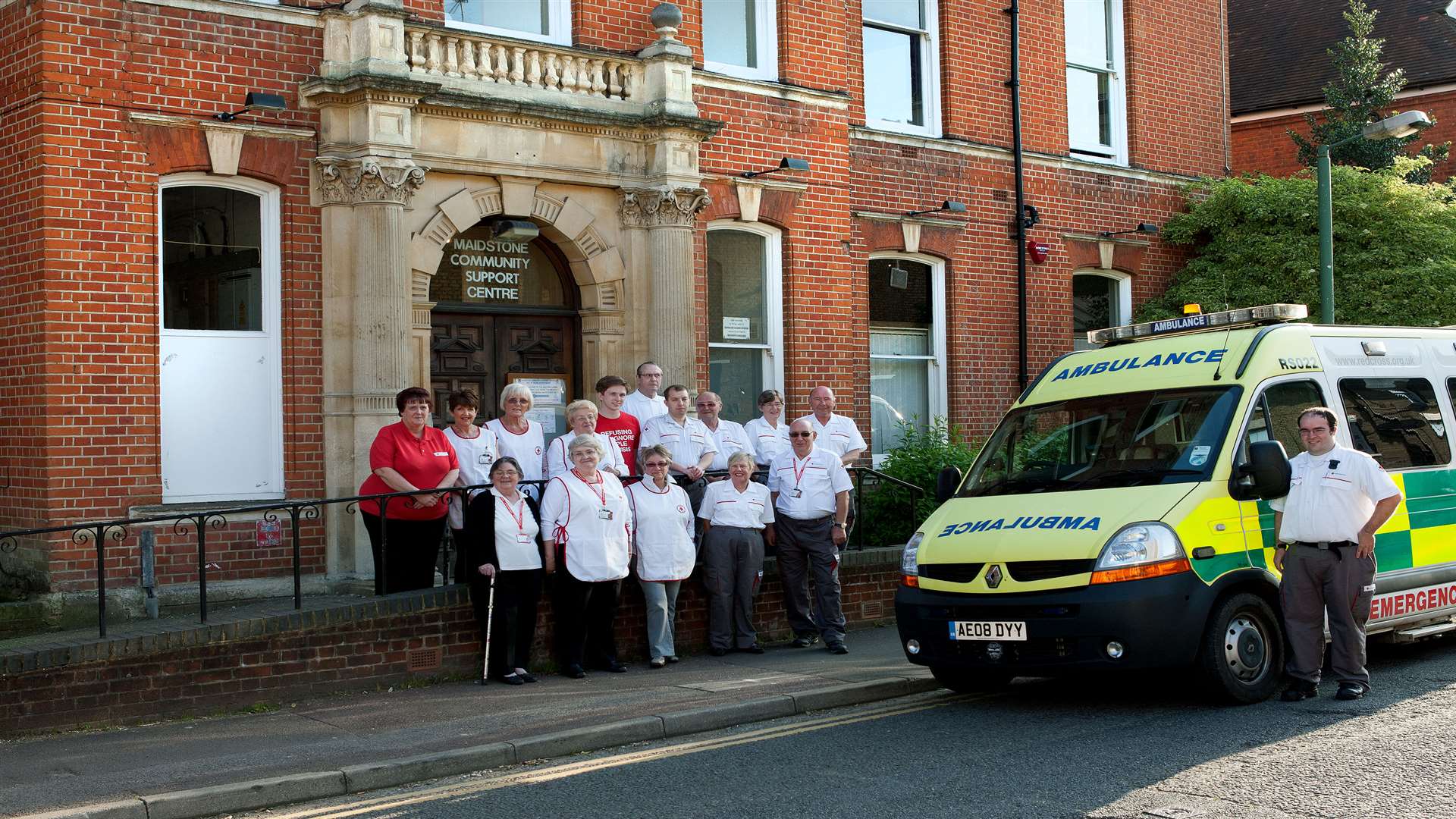 Kent Red Cross volunteers and staff with a modern Red Cross vehicle at the same location – now the offices of Voluntary Action Maidstone