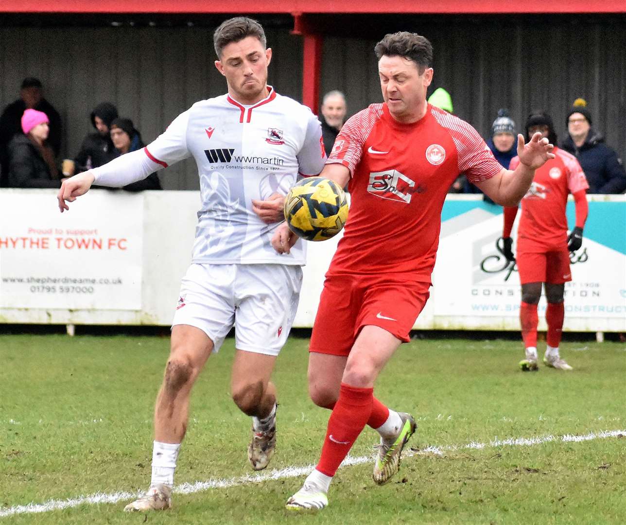 Hythe player-coach Frannie Collin (red) and former Maidstone team-magte Jack Paxman battle for the ball. Picture: Randolph File
