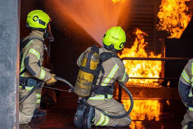Two fire engines are tackling the flames. Stock Image