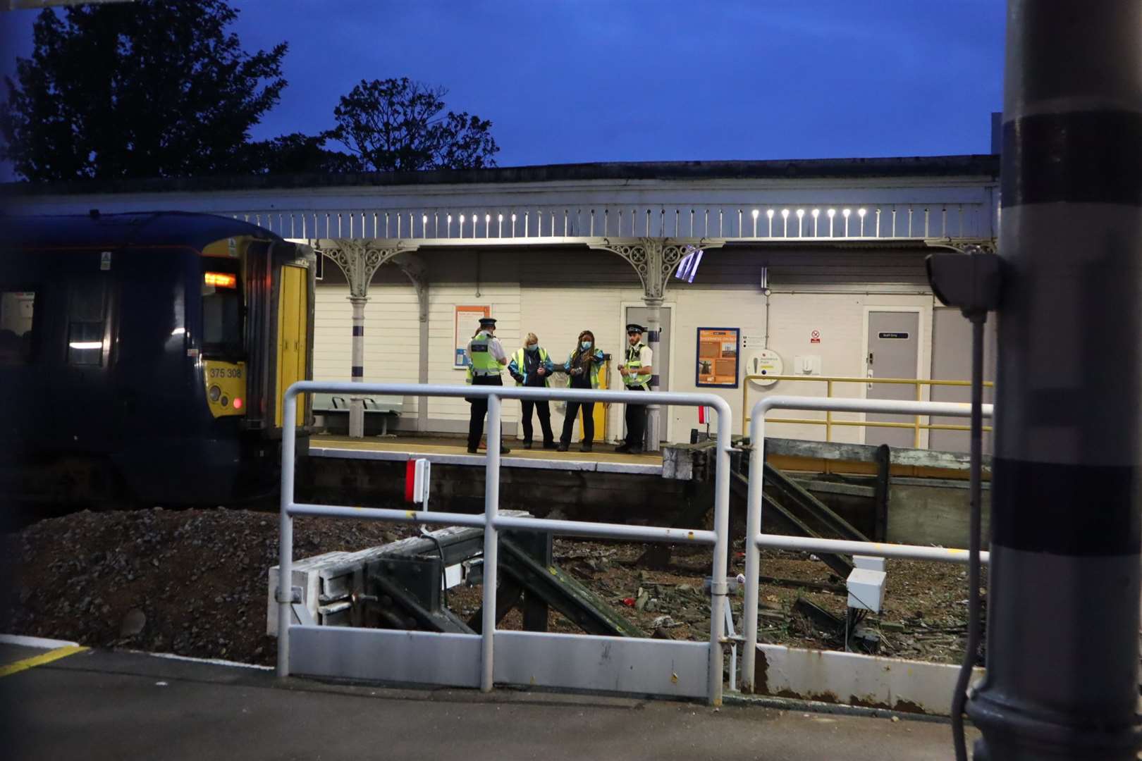 Police at Sheerness-on-Sea railway station last night with the train