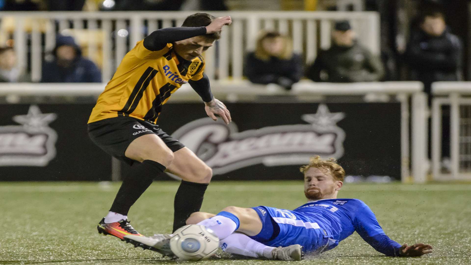 Gillingham's Connor Ogilvie tackles Maidstone's Jack Paxman Picture: Andy Payton