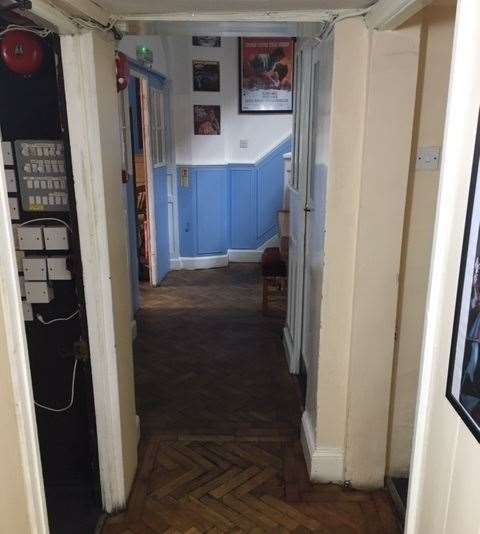 Behind the bar, the corridor proudly displays the most fantastic parquet flooring