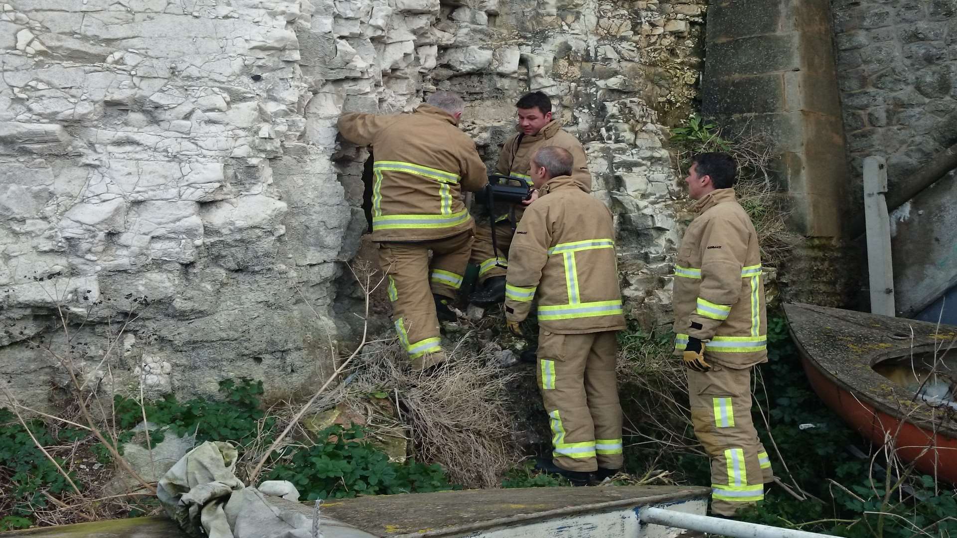 Kent Fire and Rescue team using hand tools to enlarge the hole in the cliff face. Picture: Heather Tait