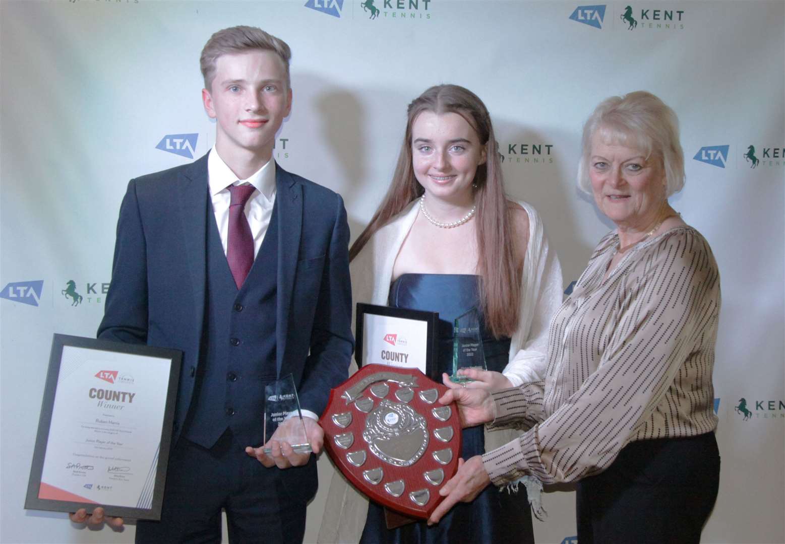 Junior players of the year Canterbury's Ruben Harris and Eloise Newbury, from Bromley, receive their awards from Kent LTA president Mary Evans