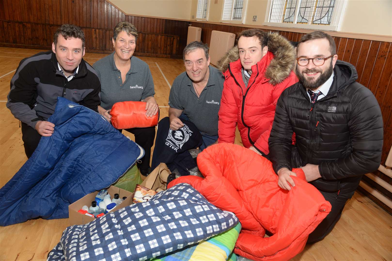 The Gravesend Messenger's Chris Hunter, left and right Daniel Green and Ed McConnell hand over some of the donations to Lorna and Stephen Nolan of Sanctuary at the Gravesend Methodist Church