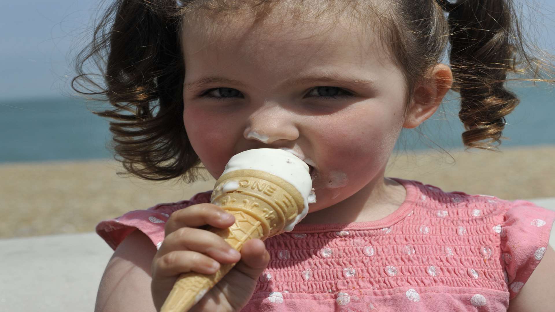 Ellie, aged two, enjoys an ice cream at Deal today. Picture Tony Flashman