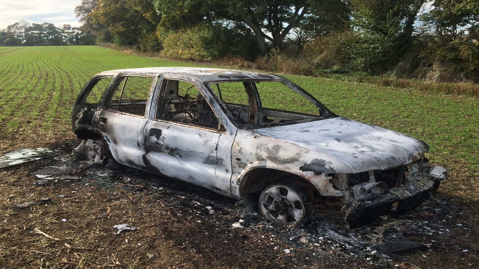 The burnt out car in a field behind Brook Street, Eastry