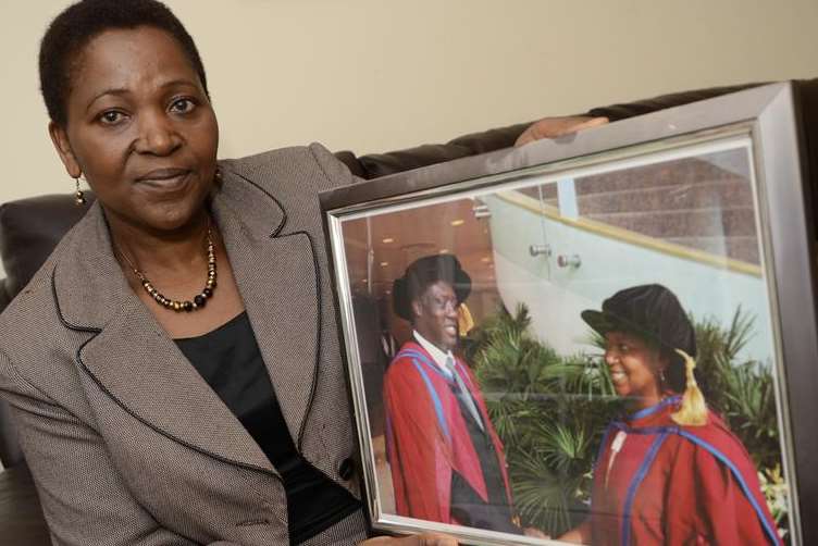 Rose Mutubaruka holds a picture of herself and her husband